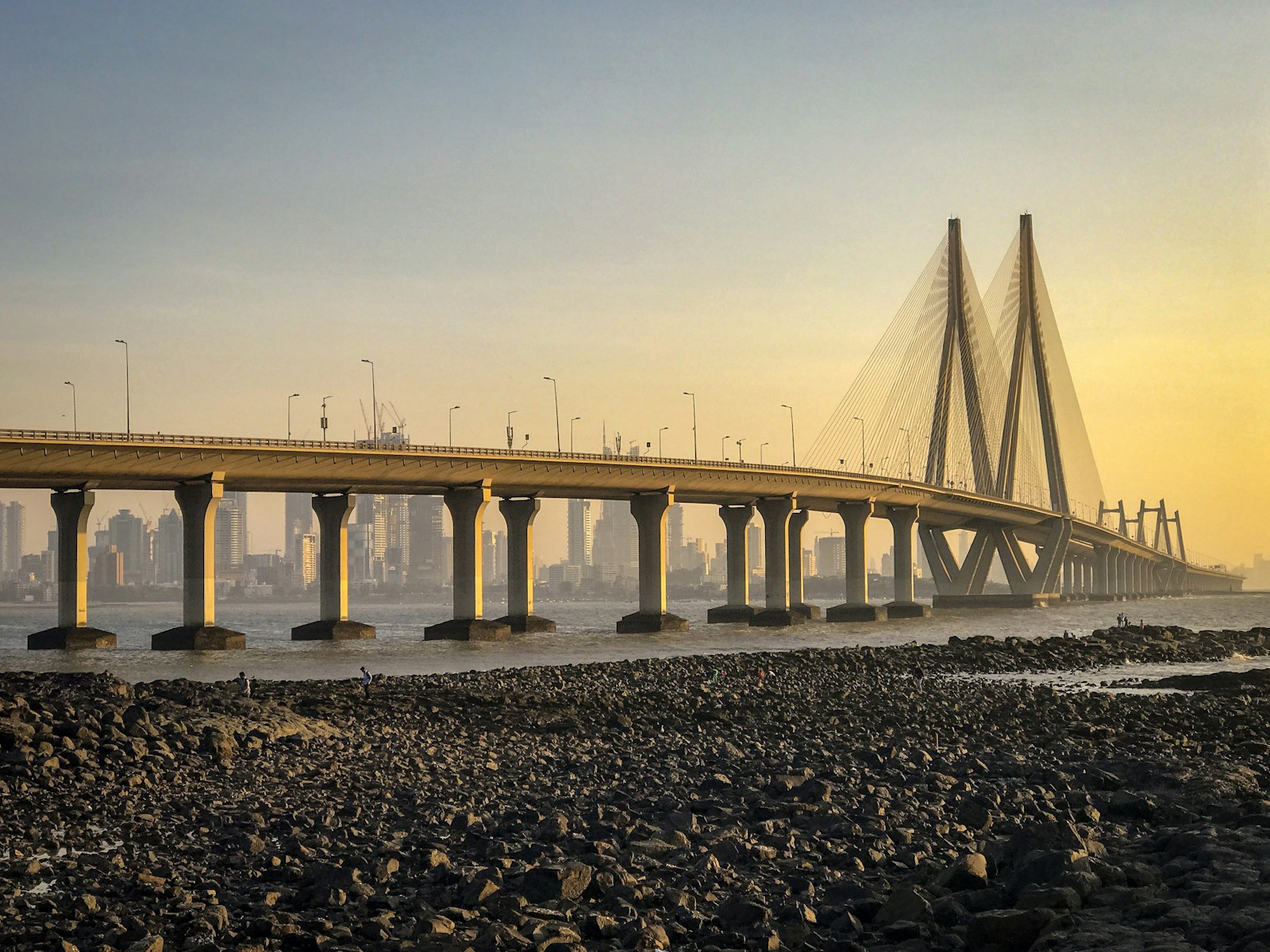 Bandra–Worli Sea Link at golden hour with the Mumbai skyline behind it